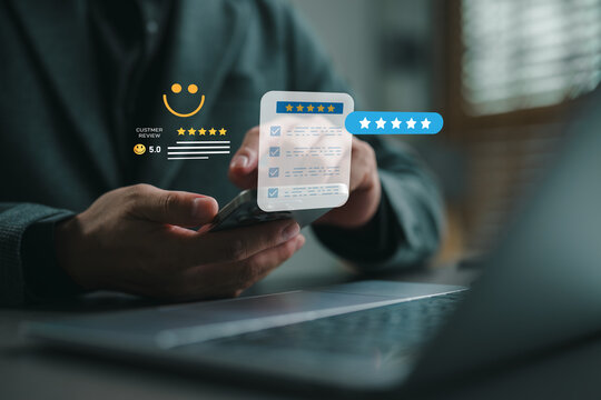 Businessman using smartphone to give five-star customer review, representing excellent service quality, high customer satisfaction, and positive feedback in digital experience.