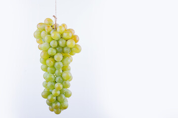 A bunch of grape hanged on the white background