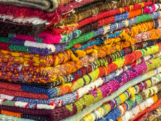 Istanbul, Turkey - August 28, 2025: Close-up of colorful woven Turkish fabrics and rugs in a traditional store