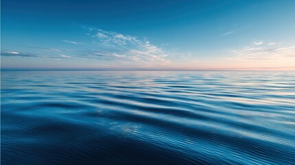 Obraz premium Tranquil Seascape at Dawn with Soft Waves and Clear Blue Sky Reflecting Peaceful Horizon Under a Gentle Sunrise Emphasizing Nature's Serenity