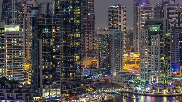 Luxury Dubai Marina canal with passing boats and promenade day to night timelapse, Dubai, United Arab Emirates