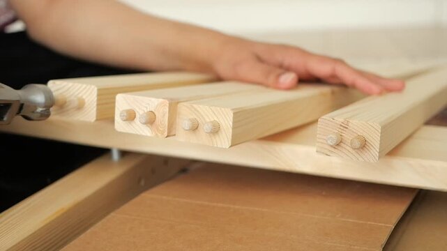 Assembling wooden furniture with hammer and dowels