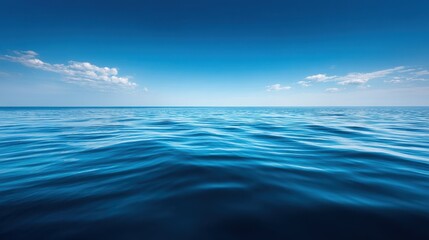 Fototapeta premium Tranquil Sea Surface Under Vast Blue Sky with Gentle Clouds Creating a Calm Oceanic Atmosphere for Relaxation and Serenity in Nature
