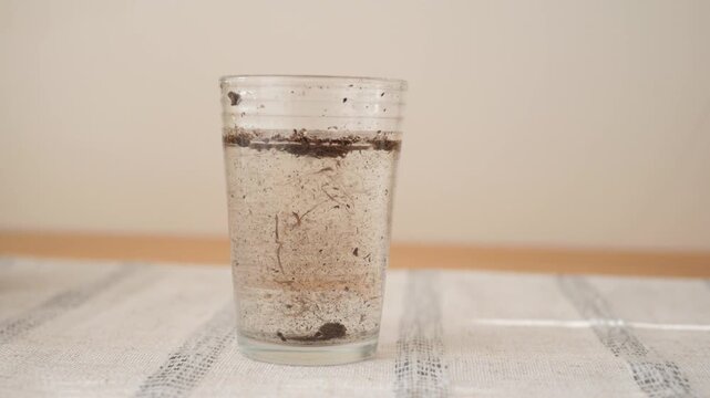 How dirt particles settle in a glass of water