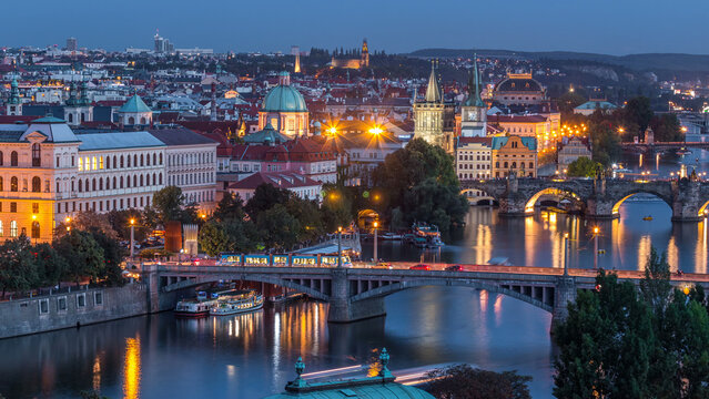 Aerial evening view of the Vltava River and illuminated bridges day to night timelapse, Prague
