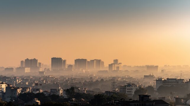 Urban skyline at sunrise with soft light and haze creating a tranquil atmosphere over the cityscape in the early morning hours
