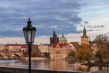 The view of Strelecky island on Vltava river and historical buildings in Smetanovo embankment with street lantern in foreground. Prague, Czech Republic 