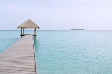 Tropical Paradise: Serene Ocean View with Dock and Thatched Roof Structure Leading to Azure Waters