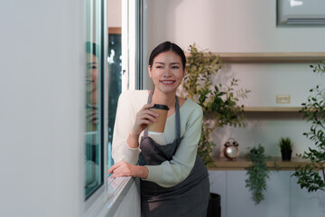 Barista smiling with coffee cup in modern cafe setting