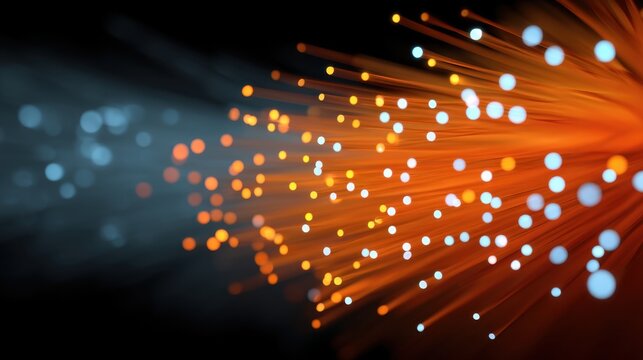 Abstract representation of vibrant light trails with glowing particles in orange and blue colors on a dark background for creative projects