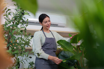 Plant Enthusiast. Woman interacting with greenery while taking notes in a sustainable shop.