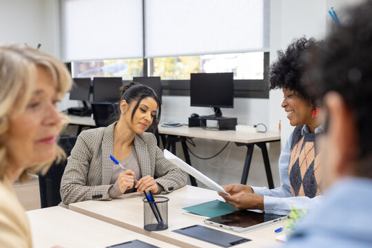 Businesswomen discussing documents during office meeting