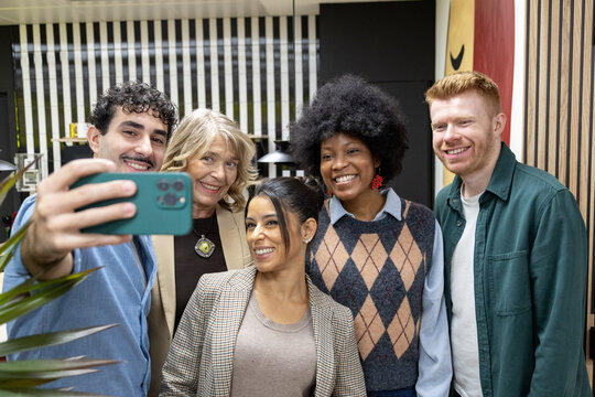 Diverse business team taking a group selfie