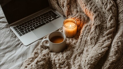 Cozy Hygge Home Office Setup With Laptop Coffee Mug And Lit Candle On Warm Knitted Blanket Working From Bed Comfort Aesthetic Stock Photography
