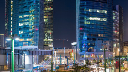 Milan skyline with modern skyscrapers in Porta Nuova business district day to night timelapse in...