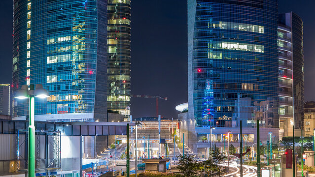 Milan skyline with modern skyscrapers in Porta Nuova business district day to night timelapse in Milan, Italy, after sunset. - Powered by Adobe