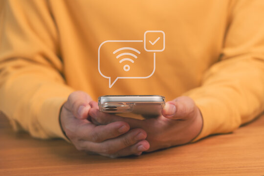 Mobile internet connection concept showing person holding smartphone with wifi signal and check mark icon, symbolizing online access, wireless communication, and digital connectivity technology.