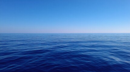 Obraz premium Serene Horizon Over Tranquil Deep Blue Ocean Water Under Clear Blue Sky on a Calm Day with Gentle Waves Reflecting Natural Beauty