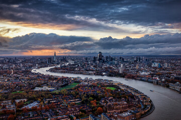 Panoramic view of the urban skyline of London, England, stretching from south to north during a moody autumn sunset with clouds