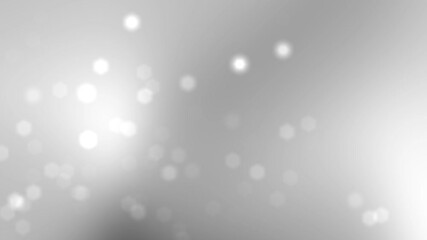 Blurry white bokeh lights on a gray gradient background for festive designs, holiday backgrounds, and elegant event invitations.