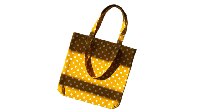 A shimmering golden tote bag with a woven texture and dark brown handles against a black background
