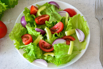 Fresh Green Salad with Tomatoes, Onions and Bell Peppers close up