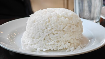Steamed white rice on plate.