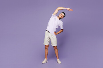 Full body young strong fitness trainer sporty man sportsman wear sportswear train in gym do stretch lunge exercise rising hands up isolated on plain purple background. Workout sport fit abs concept.
