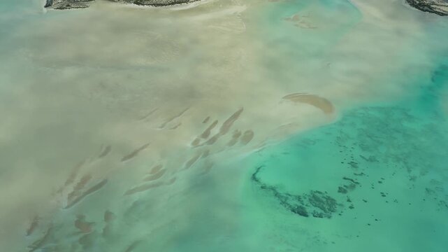 Drone-style perspective from airplane flying over Useless Loop salt fields and arid coastal landscape