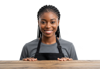 A young black woman wearing an apron smiles warmly her hands resting on a wooden surface isolated on transparent background