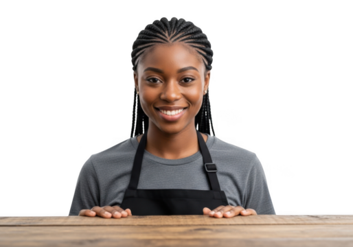 A young black woman wearing an apron smiles warmly her hands resting on a wooden surface isolated on transparent background