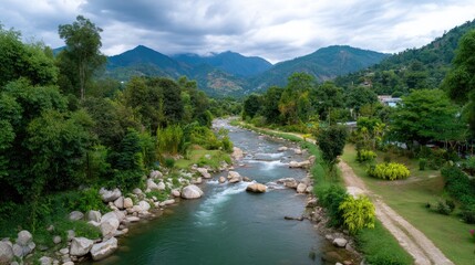 Serene River Flowing Through Lush Green Valley Surrounded by Majestic Mountains Under a Cloudy Sky in Tranquil Natural Landscape