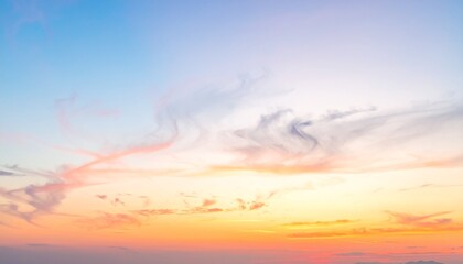 Obraz premium Gentle pastel sky with soft clouds at sunrise for background or wallpaper design and peaceful concepts.