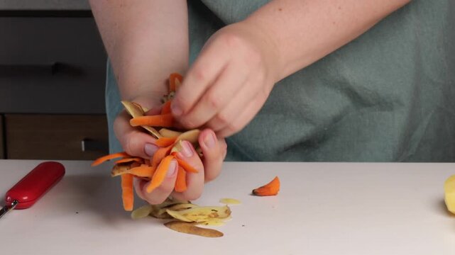 Close-up of hands collecting potato and carrot peels, eco routine reflecting mindful kitchen habits, eco vibe promoting waste reduction, eco simplicity perfect for green living themes.