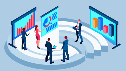 Business professionals gathered around presentation screens displaying charts and graphs in a modern office meeting room