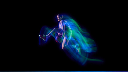 Basketball player performing aerial trick in neon motion trail. Concept of dynamic sports visuals, body control, fitness brand campaigns, and modern advertising design. © master1305