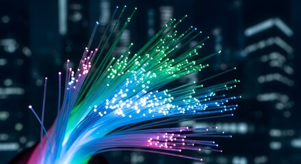 Close up of glowing colorful fiber optic strands illuminating a dark abstract background with digital patterns