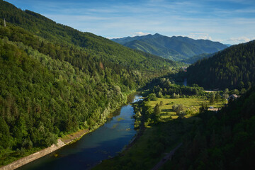 Bicaz River at the exit of the Bicaz Dam with mountains in the background