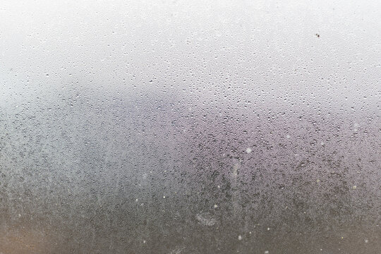 Water droplets condensation background of dew on glass, humidity and foggy blank. Outside, bad weather, rain