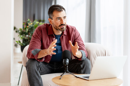Man gesturing while recording podcast or interview