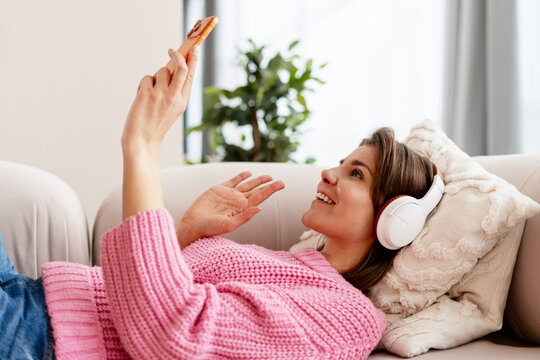 Woman relaxing at home making a video call