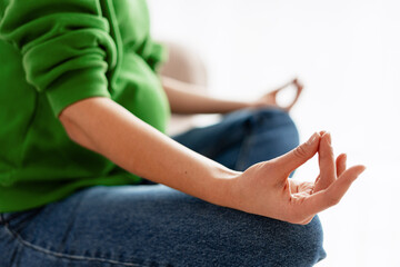 Pregnant woman meditating in yoga pose for wellness