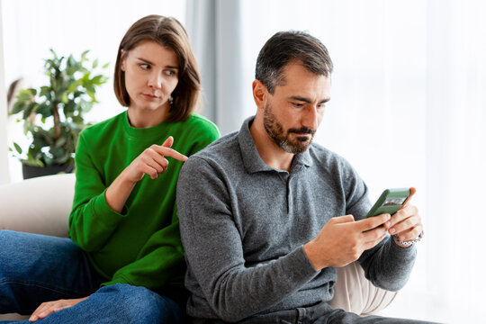 Couple experiencing conflict and jealousy over phone usage