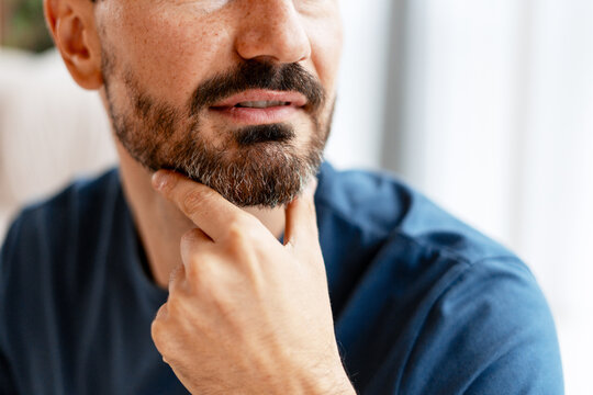 Man touching beard thinking contemplating important decisions