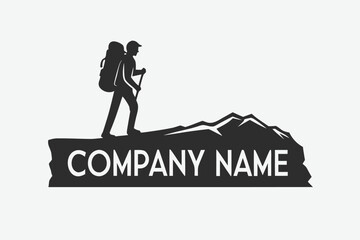 Silhouette hiker with backpack and walking stick climbs rocky mountain with company name displayed