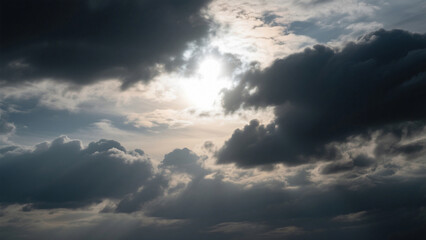 Fototapeta premium A view of a cloudy sky with the sun shining through the clouds on a bright day in the atmosphere