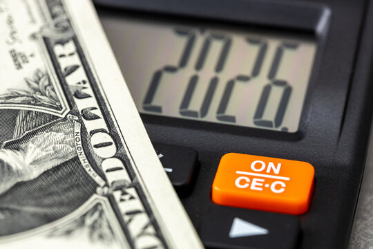 United States, 2026. Financial business concept. American economy. Symbol of the dollar and a calculator with the date 2026. US market analysis. Federal Reserve policy. Economic background. close up