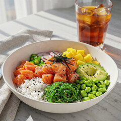 Vibrant salmon poke bowl bursting with fresh ingredients and iced tea for a healthy meal