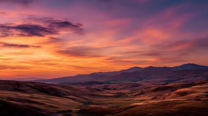 Naklejka premium Dramatic sunset over rolling hills vibrant colors painting the sky creating a serene and picturesque landscape perfect for travel and nature themes