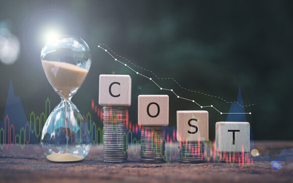 Cost reduction concept with decreasing stacked coins, COST wooden blocks, and hourglass, symbolizing efficient financial management and time-sensitive savings